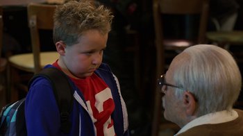 Movie still from “Jackass Presents: Bad Grandpa” (2013), directed by Jeff Tremaine – An older man talking to a young boy wearing a backpack; Close Up shot, Over the shoulder angle
