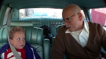 Movie still from “Jackass Presents: Bad Grandpa” (2013), directed by Jeff Tremaine – An older man and a young boy in a car; Medium shot, High angle