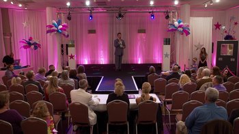 Movie still from “Jackass Presents: Bad Grandpa” (2013), directed by Jeff Tremaine – A man standing on a stage in front of an audience; Extreme Wide shot, High angle