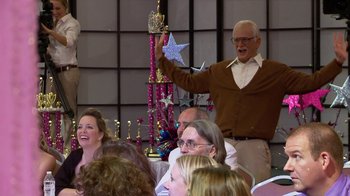 Movie still from “Jackass Presents: Bad Grandpa” (2013), directed by Jeff Tremaine – An older man holding a star in front of a group of people; Medium shot, Low angle