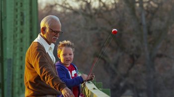 Movie still from “Jackass Presents: Bad Grandpa” (2013), directed by Jeff Tremaine – An older man and a young boy are holding a fishing pole; Close Up shot, Low angle