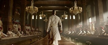 Movie still from “Bajirao Mastani” (2015), directed by Sanjay Leela Bhansali – A man in a long white robe walking down a runway; Wide shot, Low angle