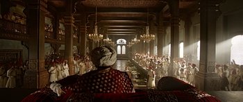 Movie still from “Bajirao Mastani” (2015), directed by Sanjay Leela Bhansali – A group of people standing in a large room; Extreme Wide shot, Over the shoulder angle