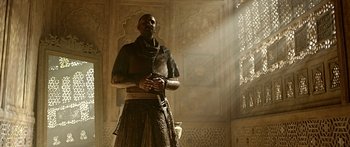 Movie still from “Bajirao Mastani” (2015), directed by Sanjay Leela Bhansali – A man standing in front of a window with a sword; Medium shot, Low angle