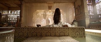 Movie still from “Bajirao Mastani” (2015), directed by Sanjay Leela Bhansali – A woman with long hair sitting on a bench; Wide shot, Over the shoulder angle