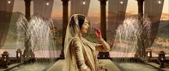 Movie still from “Bajirao Mastani” (2015), directed by Sanjay Leela Bhansali – A woman in a white dress and a veil is holding her hands up in the air; Medium shot, Over the shoulder angle