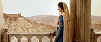 Movie still from “Bajirao Mastani” (2015), directed by Sanjay Leela Bhansali – A woman standing on a balcony looking out at the mountains; Wide shot, Over the shoulder angle