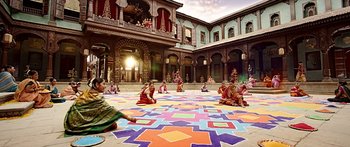 Movie still from “Bajirao Mastani” (2015), directed by Sanjay Leela Bhansali – A group of people sitting on the ground in front of a building; Extreme Wide shot, High angle