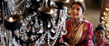 Movie still from “Bajirao Mastani” (2015), directed by Sanjay Leela Bhansali – A woman in a sari is standing in front of a chandelier; Close Up shot, Over the shoulder angle