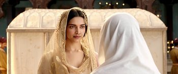 Movie still from “Bajirao Mastani” (2015), directed by Sanjay Leela Bhansali – Deepika padukon in a gold dress and a veil; Close Up shot, Over the shoulder angle