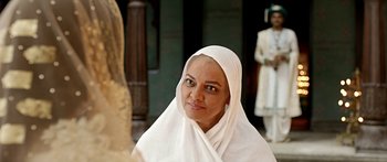 Movie still from “Bajirao Mastani” (2015), directed by Sanjay Leela Bhansali – A woman in a white headscarf is posing for a picture; Close Up shot, Over the shoulder angle