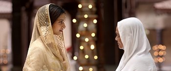 Movie still from “Bajirao Mastani” (2015), directed by Sanjay Leela Bhansali – Two women are talking to each other in front of lights; Close Up shot, Over the shoulder angle