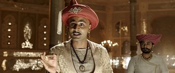 Movie still from “Bajirao Mastani” (2015), directed by Sanjay Leela Bhansali – A man in a red hat and a gold jacket; Close Up shot, Low angle