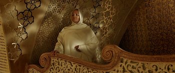Movie still from “Bajirao Mastani” (2015), directed by Sanjay Leela Bhansali – A woman wearing a white veil standing on a wooden bench; Medium shot, Low angle