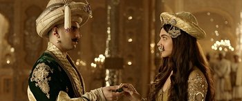 Movie still from “Bajirao Mastani” (2015), directed by Sanjay Leela Bhansali – A man and a woman are dressed up and holding hands; Close Up shot, Over the shoulder angle