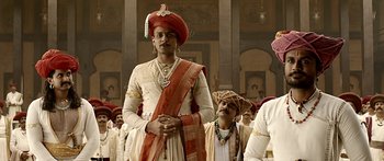 Movie still from “Bajirao Mastani” (2015), directed by Sanjay Leela Bhansali – A man in a red turban standing in front of other men; Medium shot, Low angle
