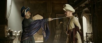 Two men in medieval garb are fighting with swords