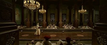 Movie still from “Bajirao Mastani” (2015), directed by Sanjay Leela Bhansali – A group of people sitting in a large room with chandeliers; Extreme Wide shot, High angle