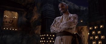 Movie still from “Bajirao Mastani” (2015), directed by Sanjay Leela Bhansali – A man with a beard standing with his arms crossed in front of a building; Medium shot, Low angle