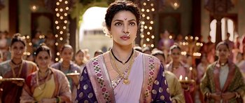 Movie still from “Bajirao Mastani” (2015), directed by Sanjay Leela Bhansali – A woman in a purple and white sari with a gold necklace; Close Up shot, Over the shoulder angle