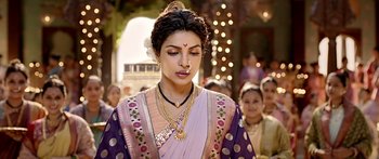 Movie still from “Bajirao Mastani” (2015), directed by Sanjay Leela Bhansali – A woman in a purple and white sari with a gold necklace; Close Up shot, Over the shoulder angle