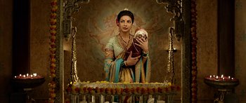 Movie still from “Bajirao Mastani” (2015), directed by Sanjay Leela Bhansali – A woman holding a coconut in her hands; Medium shot, Low angle