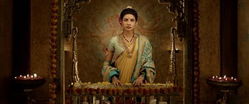 Movie still from “Bajirao Mastani” (2015), directed by Sanjay Leela Bhansali – A woman standing in front of a table with flowers; Medium shot, Low angle