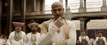 Movie still from “Bajirao Mastani” (2015), directed by Sanjay Leela Bhansali – A man with a bald head is posing for a picture; Close Up shot, Low angle