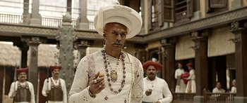 Movie still from “Bajirao Mastani” (2015), directed by Sanjay Leela Bhansali – A man with a white hat and a beard smoking a cigarette; Close Up shot, Low angle