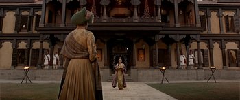 Movie still from “Bajirao Mastani” (2015), directed by Sanjay Leela Bhansali – A man and a woman are standing in front of a building; Wide shot, Low angle