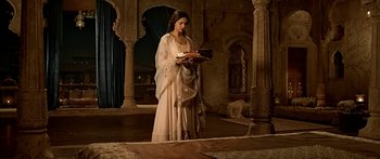 Movie still from “Bajirao Mastani” (2015), directed by Sanjay Leela Bhansali – A woman in a long dress holding a tray of food; Wide shot, High angle