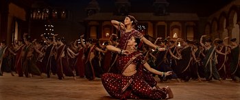 Movie still from “Bajirao Mastani” (2015), directed by Sanjay Leela Bhansali – A couple of women are dancing on the ground; Wide shot, Low angle