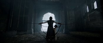 Movie still from “Bajirao Mastani” (2015), directed by Sanjay Leela Bhansali – A woman and a child are chained up in a dark room; Wide shot, Low angle
