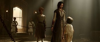 Movie still from “Bajirao Mastani” (2015), directed by Sanjay Leela Bhansali – A man and a woman standing next to each other in chains; Wide shot, Low angle