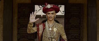 Movie still from “Bajirao Mastani” (2015), directed by Sanjay Leela Bhansali – A man wearing a red turban and a gold outfit; Medium shot, Over the shoulder angle