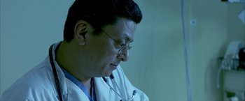 Movie still from “Ballast” (2008), directed by Lance Hammer – A man in a white lab coat with a stethoscope around his neck; Close Up shot, Low angle