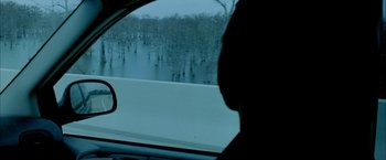 Movie still from “Ballast” (2008), directed by Lance Hammer – A person sitting in a car looking out the window; Extreme Wide shot, High angle