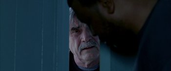 Movie still from “Ballast” (2008), directed by Lance Hammer – An older man with a mustache looking at the camera; Close Up shot, Over the shoulder angle