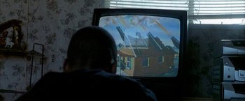 Movie still from “Ballast” (2008), directed by Lance Hammer – A man sitting in front of a television; Extreme Close Up shot, Over the shoulder angle