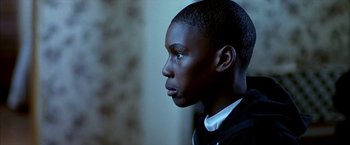 Movie still from “Ballast” (2008), directed by Lance Hammer – A young person looking to the side; Close Up shot, Over the shoulder angle