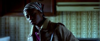 Movie still from “Ballast” (2008), directed by Lance Hammer – A woman wearing a head scarf and a brown jacket; Close Up shot, Low angle