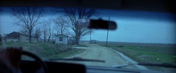 Movie still from “Ballast” (2008), directed by Lance Hammer – A view of a dirt road from a car window; Extreme Wide shot, High angle