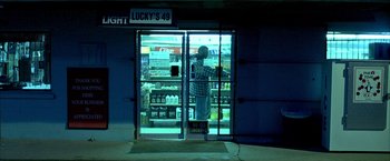 Movie still from “Ballast” (2008), directed by Lance Hammer – A man standing in front of a store window; Wide shot, Low angle