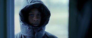 Movie still from “Ballast” (2008), directed by Lance Hammer – A young man wearing a hooded jacket looking into the camera; Close Up shot, Over the shoulder angle