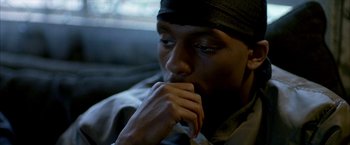 Movie still from “Ballast” (2008), directed by Lance Hammer – A person sitting in a car with his hand under his chin; Close Up shot, Over the shoulder angle