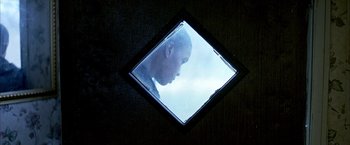 Movie still from “Ballast” (2008), directed by Lance Hammer – A picture of a man's face through a window; Extreme Close Up shot, Low angle