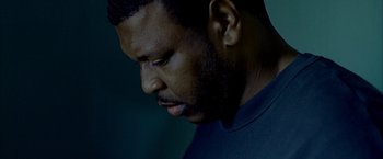 Movie still from “Ballast” (2008), directed by Lance Hammer – A person looking down at his face; Close Up shot, Low angle