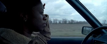 Movie still from “Ballast” (2008), directed by Lance Hammer – A person sitting in a car looking out the window; Close Up shot, Over the shoulder angle