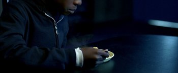 Movie still from “Ballast” (2008), directed by Lance Hammer – A person sitting at a table with a plate of food; Extreme Close Up shot, High angle