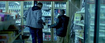 Movie still from “Ballast” (2008), directed by Lance Hammer – Two men standing in front of refrigerators in a store; Medium shot, Over the shoulder angle